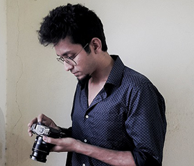 Santasil Mallik holding a camera