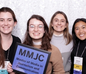 MMJC alumni proudly hold MMJC sign