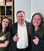 Group photo of Meghan Voll, Mark Ambrogio and Amalie Hutchinson with their thumbs up