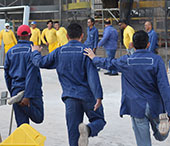 Workers stretching at a construction site