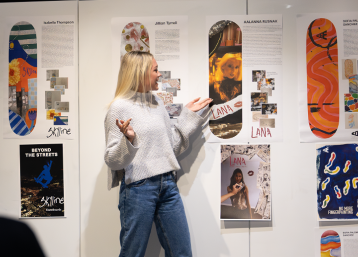 a female student presenting their graphic design work