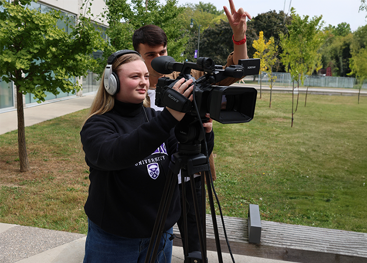 two students behind the camera