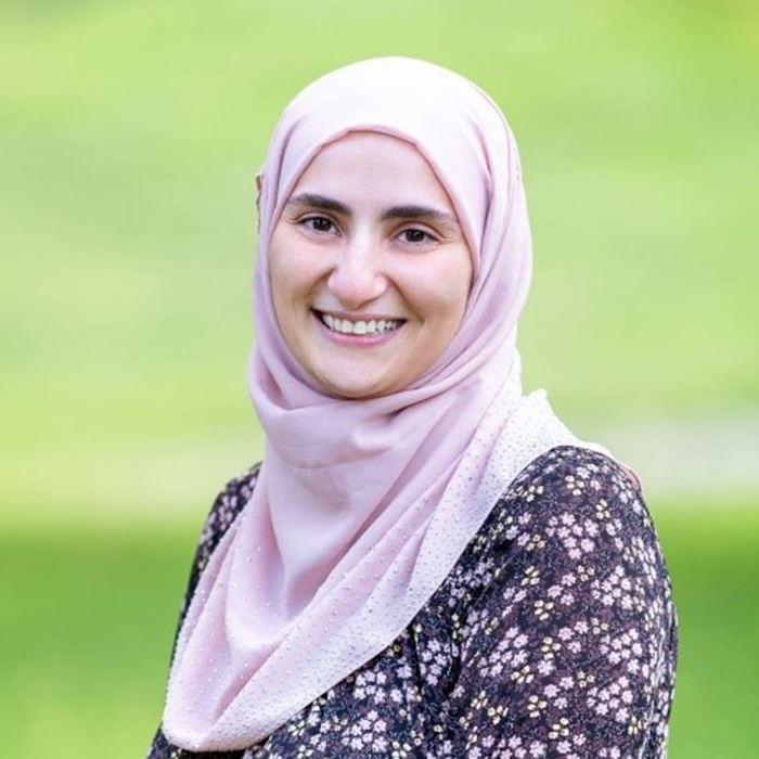 Headshot of Sarah Alakshar outside surrounded by green grass