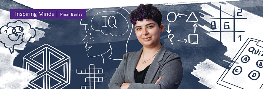 Pinar Barlas standing against original artwork depicting her research