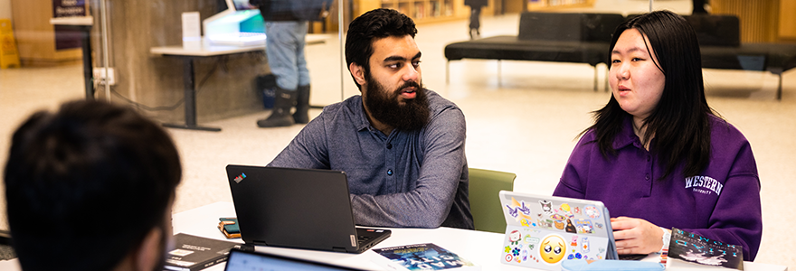 Three students sitting at a table studying