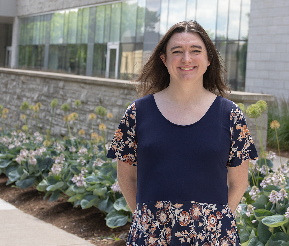 Bri Watson stands in the sunshine outside the FIMS & Nursing Building