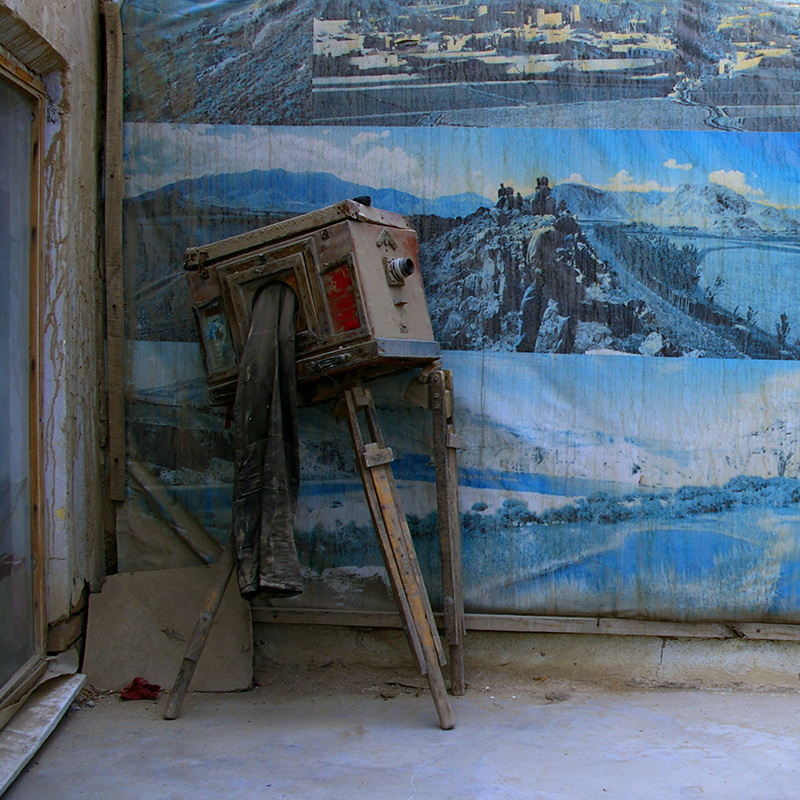 Antique cameral leaning against a painted backdrop