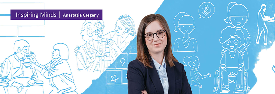 Anastazia Csegeny standing in front of Inspiring Minds artwork