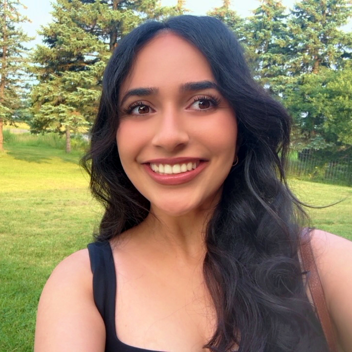 Headshot of Harleen Grewal outside in front of green grass and trees
