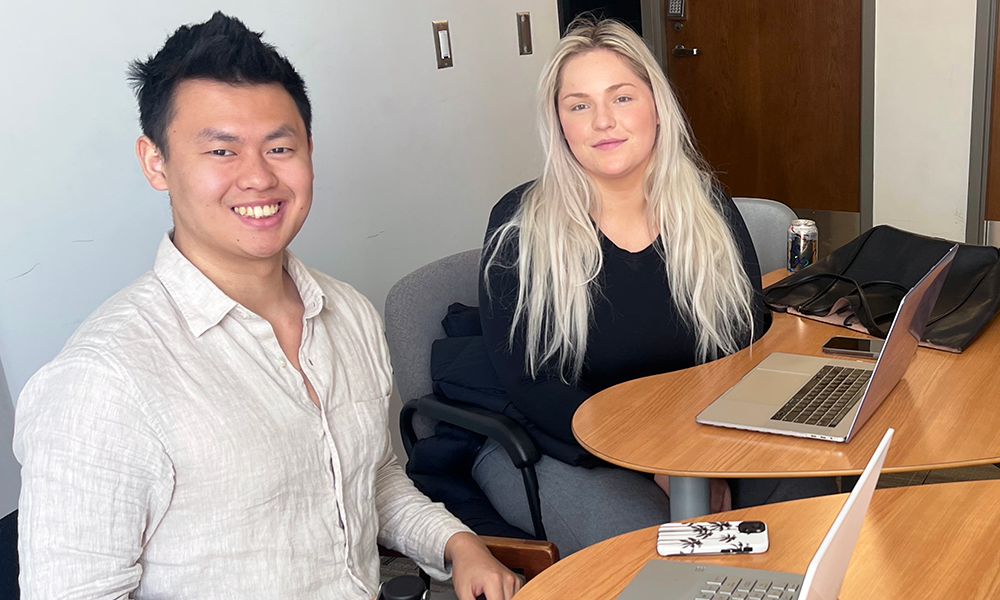 Two students working at desks in the FIMS & Nursing Building