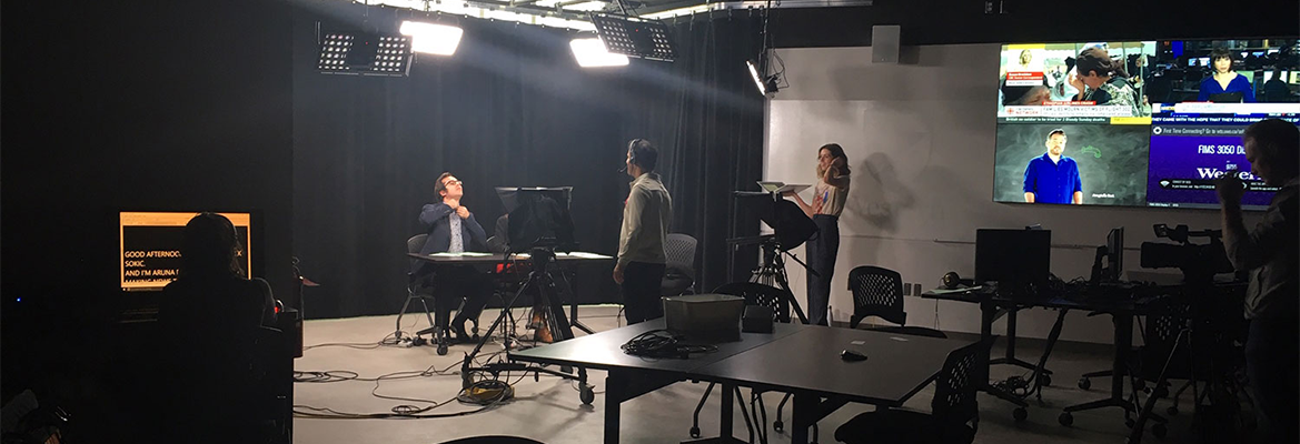 Students prepping for a newscast in the broadcast studio
