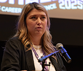 Headliner Brooke Morgan speaking into a mic at Careerchella.