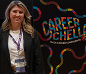 Alumna Brooke Morgan next to her Careerchella promotional poster.