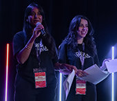 Rhea and Emilia, Careerchella student hosts, speak on stage at the Wave.