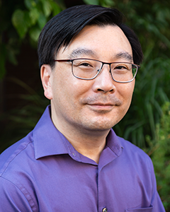 Headshot of Cabot Yu, wearing glasses and in a lavender shirt.