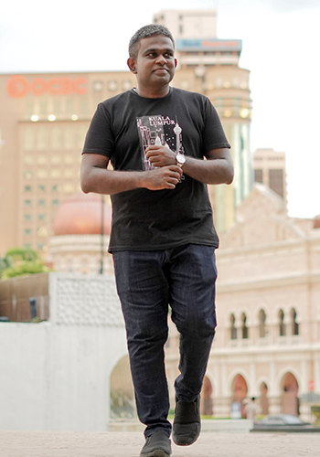 Photo of Prabu Nadaraja standing outside in a city.
