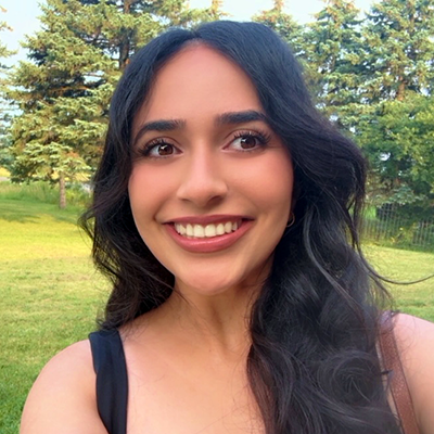 Headshot of Harleen Grewal outside in front of green grass and trees