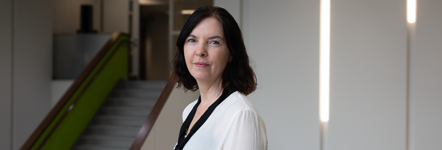 Joanna Leaning against a staircase