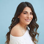 View across the water to the opposite short and hills in the background.