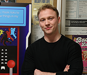 Henry Standage (BA'21) stands in front of his Career Conference promotional poster.
