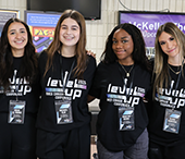 MACS student volunteers staff the conference registration table.