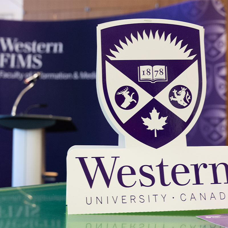 The Western University logo in the foreground with a purple banner in the background.