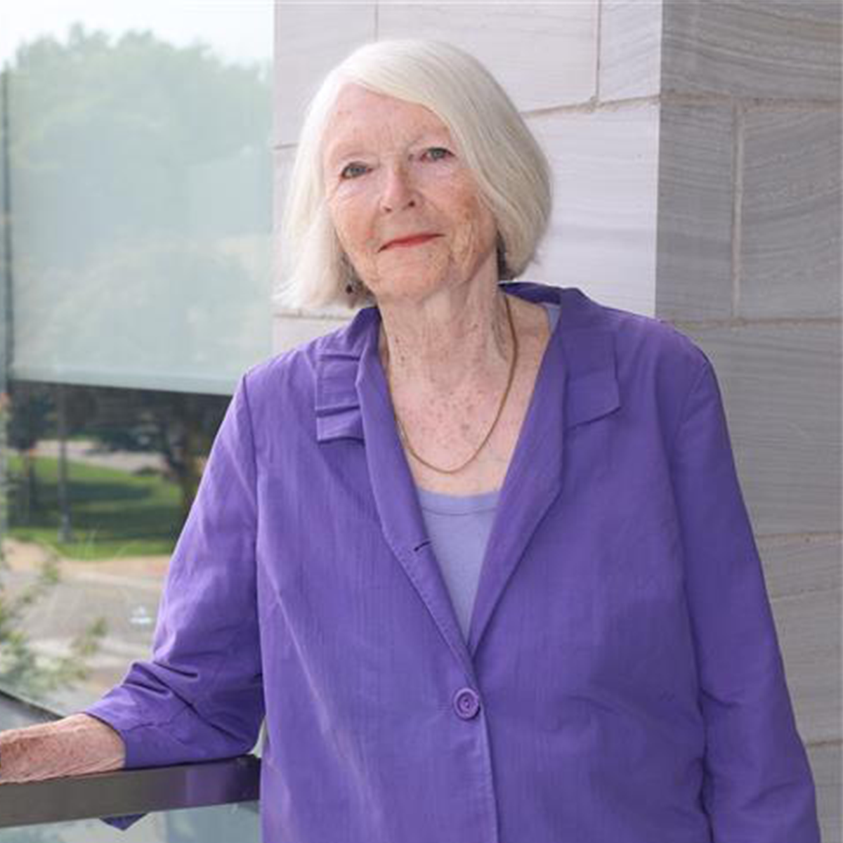 Catherine Ross, a FIMS donor, is standing outside the FIMS and Nursing building