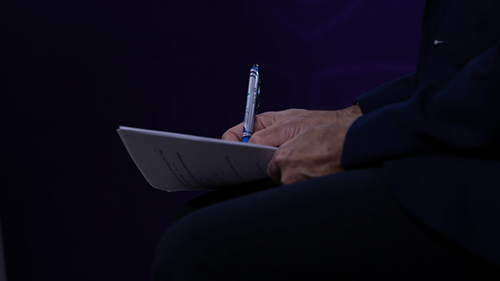 Hand writing on a pad of paper