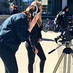 Students practicing camera work on campus.